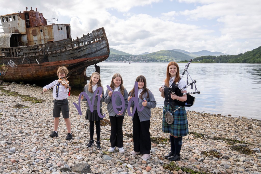 Young musicians on beach in Loch Abar